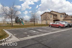 Uncovered parking lot featuring fence and playground community