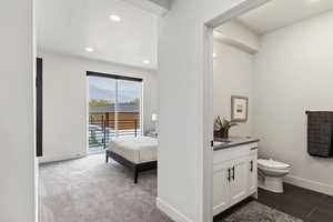 Bathroom with recessed lighting, toilet, vanity, and baseboards