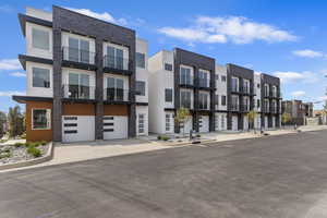 View of building exterior featuring driveway and an attached garage