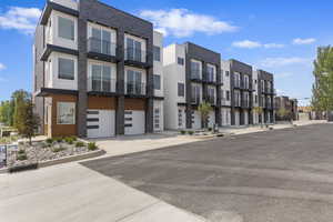 View of building exterior featuring driveway and an attached garage