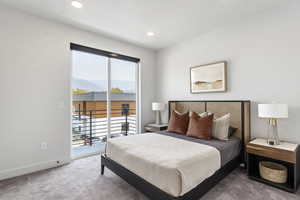 Carpeted bedroom featuring baseboards, recessed lighting, a mountain view, and access to exterior