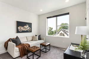 Living room with carpet, baseboards, and recessed lighting