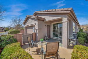 View of patio / terrace featuring an attached garage, fence, and area for grilling