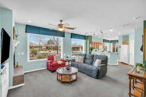 Living area featuring baseboards, a ceiling fan, carpet flooring, and recessed lighting