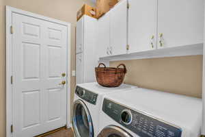 Clothes washing area with cabinet space and washing machine and clothes dryer