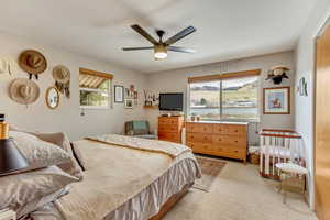 Bedroom featuring light carpet and ceiling fan