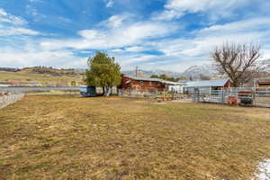 View of yard with an outbuilding and fence