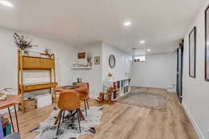 Office space featuring baseboards, recessed lighting, and light wood-style floors