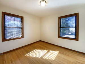 Empty room with baseboards and wood finished floors