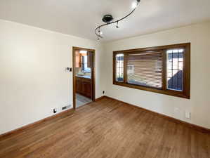 Unfurnished room featuring light wood-type flooring, a sink, visible vents, and baseboards