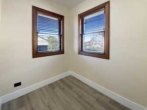 Unfurnished room with light wood-style flooring and baseboards