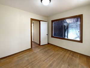 Spare room with light wood-style floors, visible vents, and baseboards