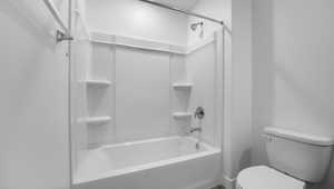 Bathroom with toilet and bathtub / shower combination