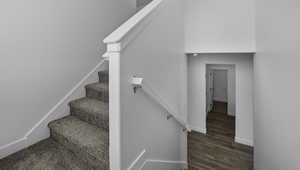 Stairway with baseboards and wood finished floors