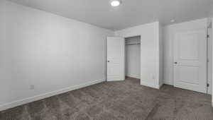 Unfurnished bedroom with carpet, baseboards, and a closet