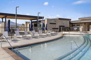 Pool featuring fence, a mountain view, and a patio