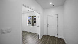 Foyer featuring recessed lighting, wood finished floors, visible vents, and baseboards