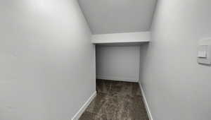 Corridor featuring carpet flooring and baseboards