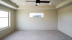 Empty room featuring a healthy amount of sunlight, visible vents, carpet flooring, and recessed lighting