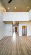 Unfurnished living room with light wood-type flooring, visible vents, and recessed lighting