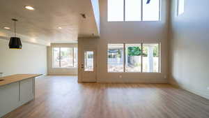 Unfurnished living room with baseboards, recessed lighting, visible vents, and light wood-style floors