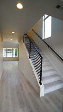 Staircase featuring visible vents, baseboards, and wood finished floors