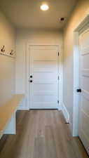 Mudroom with baseboards, wood finished floors, visible vents, and recessed lighting