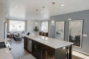 Kitchen featuring dishwasher, open floor plan, a sink, and a wealth of natural light