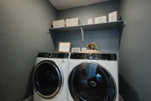 Laundry area featuring laundry area and washing machine and clothes dryer