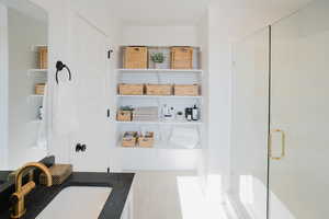Interior space with a stall shower and vanity