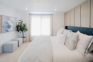 Carpeted bedroom with recessed lighting