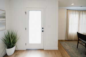 Foyer with visible vents, baseboards, and wood finished floors