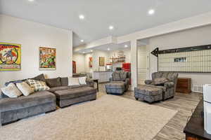 Living area with baseboards, wood finished floors, visible vents, and recessed lighting