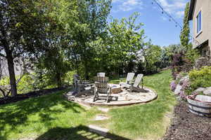 View of yard featuring a patio and a fire pit