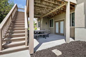 View of patio / terrace with french doors, stairway, and outdoor dining space