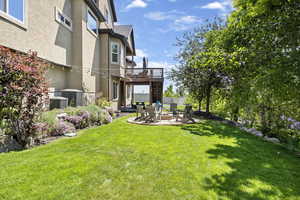 View of yard with central air condition unit, stairway, a patio area, a fire pit, and a wooden deck