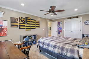 Bedroom with ceiling fan, recessed lighting, ornamental molding, a closet, and carpet