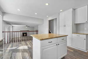 Kitchen with dark wood-style floors, recessed lighting, white cabinets, and a ceiling fan