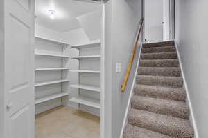 Stairs with tile patterned floors