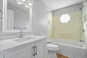 Full bathroom with toilet, shower / bath combination, wood finished floors, and vanity