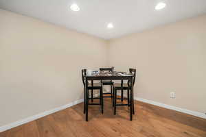 Dining area featuring hardwood / wood-style floors, recessed lighting, and baseboards