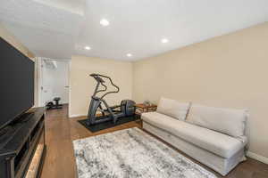 Workout area featuring hardwood / wood-style flooring, recessed lighting, and baseboards