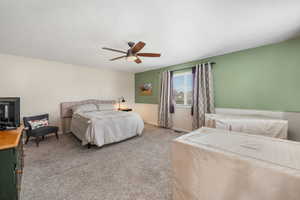 Bedroom featuring carpet flooring, a ceiling fan, and baseboards