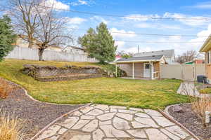 View of yard featuring a gate, a fenced backyard, a patio, and central AC unit