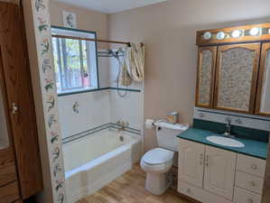 Bathroom with shower / tub combo, toilet, vanity,