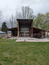 View of pole building with a lawn