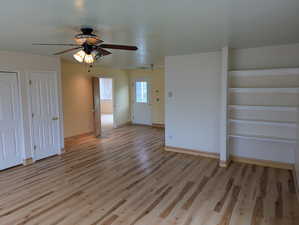 Interior space featuring baseboards, light wood-style floors, and ceiling fan