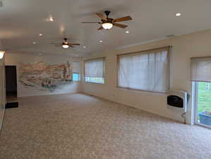 Unfurnished living room with heating unit, recessed lighting, a ceiling fan, and a healthy amount of sunlight
