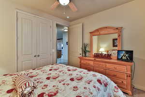 Bedroom featuring ceiling fan and a closet