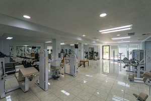 Gym with light tile patterned flooring, visible vents, and recessed lighting